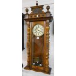 An early 20th Century walnut cased Vienna style regulator wall clock with ornate pediment,