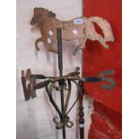 An old wrought iron and copper weathervane with horse finial