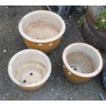 A set of three graduated green glazed garden pots