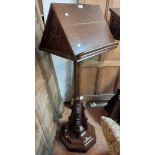 A late Victorian Gothic style double slope sided lectern with flanking bosses, set on a faceted