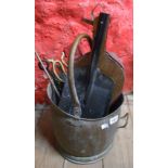 A helmet coal bucket containing a quantity of fireside equipment including bellows, shovels, fire
