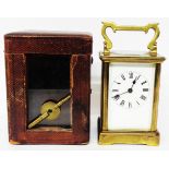 An early 20th Century brass and bevelled glass cased carriage timepiece with Roman numerals to