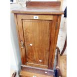 An Edwardian mahogany and strung pot cupboard enclosed by a panelled door