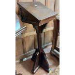 A late Victorian stained oak Gothic style lectern with flanking carved decoration and bosses