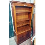 *A 91cm reproduction mahogany two part bookcase with three open shelves to top over a base with