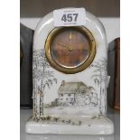 An early 20th century ceramic dome top desk timepiece with cottage decoration and simple thirty hour