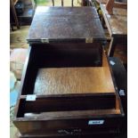 A vintage wooden table desk with lift-top lid and drawer to front