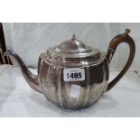 A silver oval ribbed teapot with engraved decoration and wooden handle - lid finial insulator