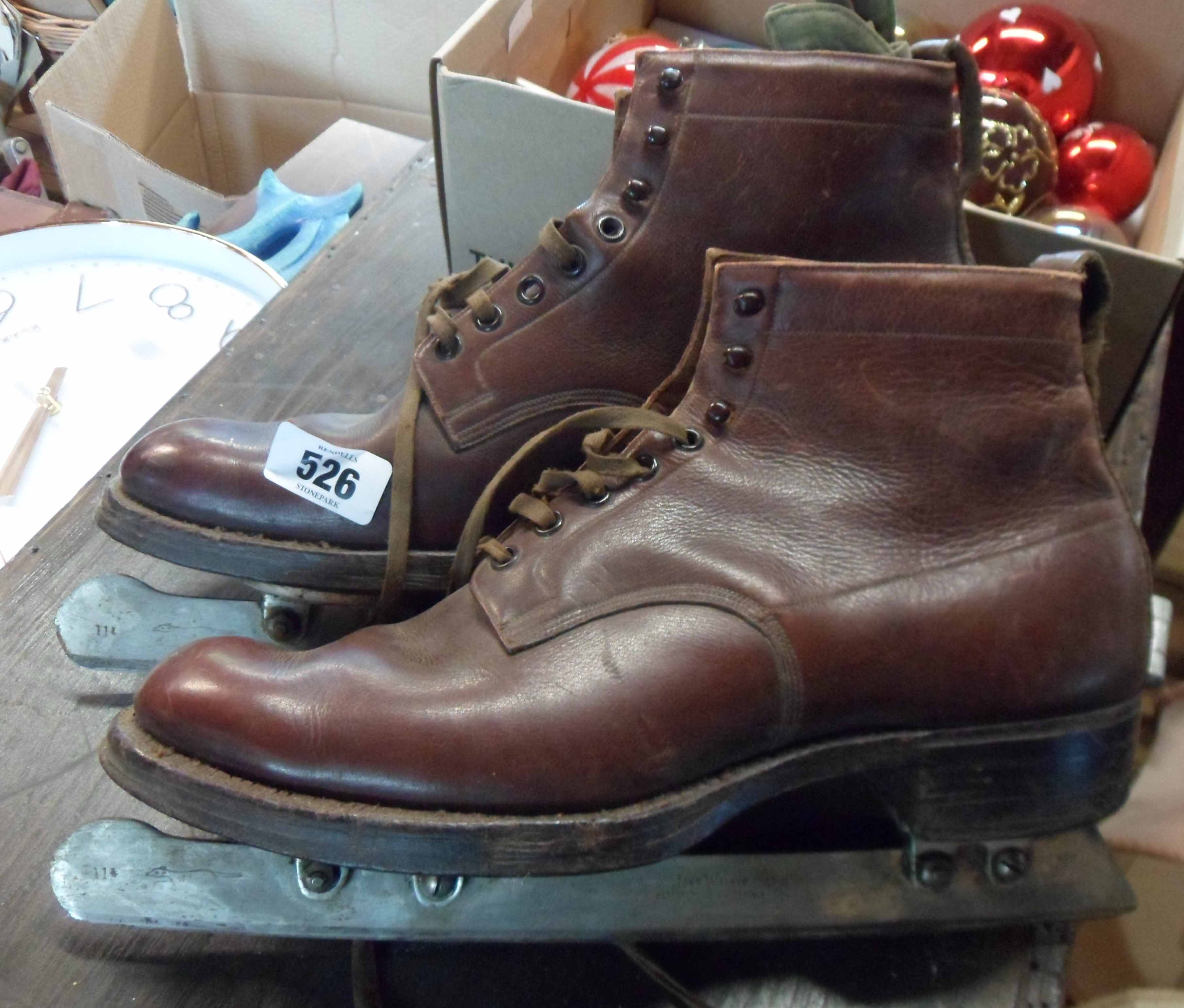 A pair of vintage John Wilson ice skates with brown leather boots