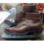 A pair of vintage John Wilson ice skates with brown leather boots