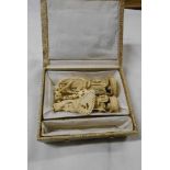Two Chinese carved ivory figures - sold with a carved ivory necklace contained in a later box