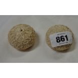 A pair of Chinese carved ivory paperweights of cushion form with all over decorative scrolling