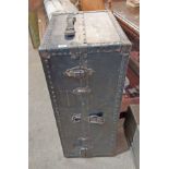 An early 20th Century travelling wardrobe trunk with flight of five graduated drawers and fold-out