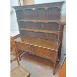 A 1.37m 20th Century Williams & Cox polished oak two part dresser with two shelf open plate rack