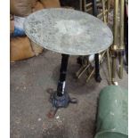 A cast iron garden table of pedestal form with circular marble top