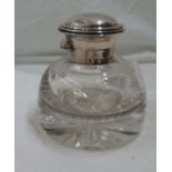 A silver flip-top glass inkwell with star cut base and nib well to top - dents and initial to lid