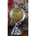An Art Deco style globe of the world with aeroplane to top