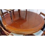 A 1.52m diameter late Chinese hardwood dining table with moulded top, set on a faceted pedestal base