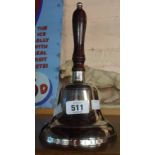 A modern cast hand bell with wooden handle