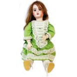 An antique Jumeau porcelain headed doll with open mouth, jointed composition body and lace trimmed