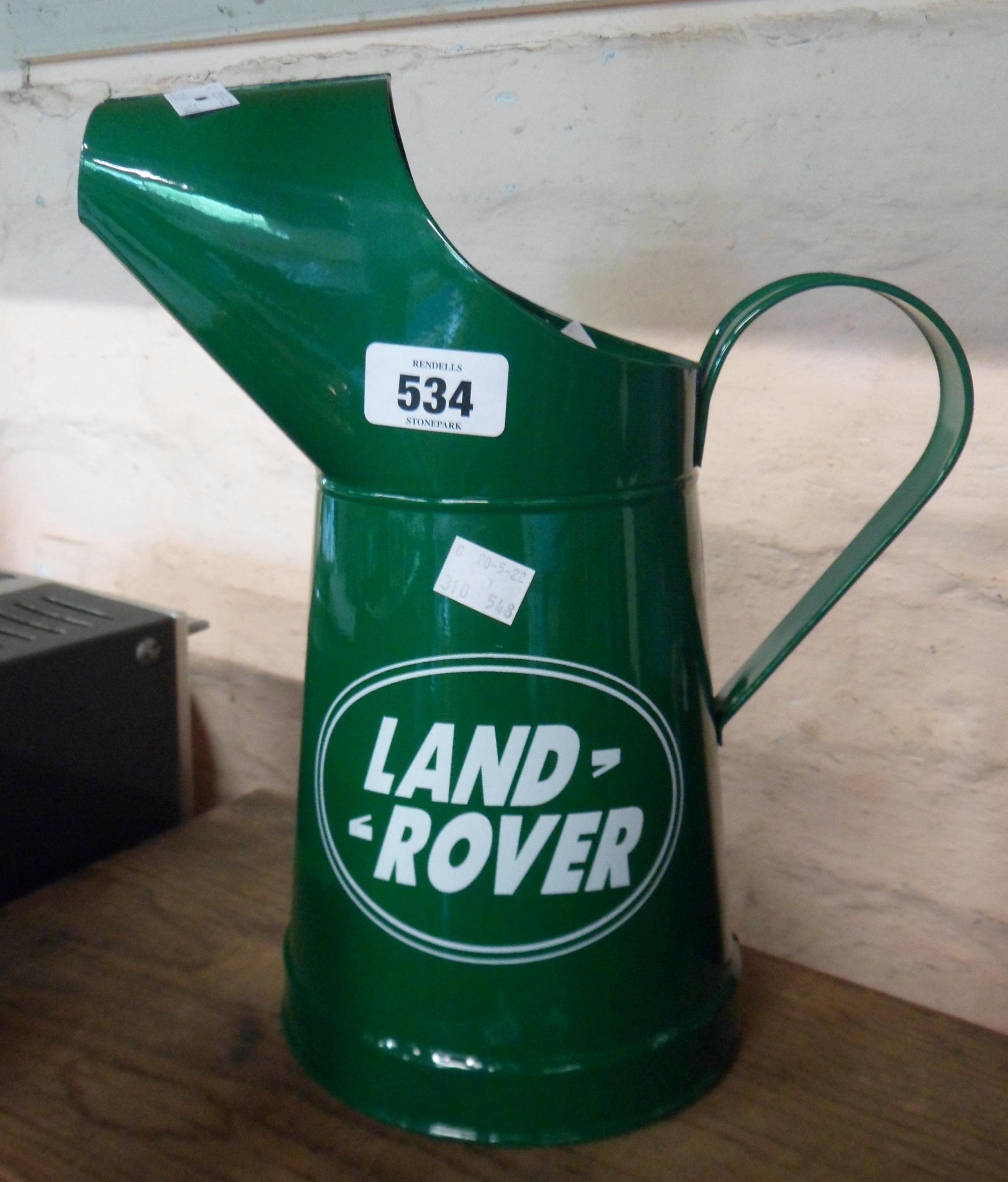 A modern painted pressed tin Landrover oil jug