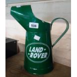A modern painted pressed tin Landrover oil jug