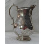 A silver cream jug with cast C-scroll handle and engraved decoration - marked for Widdowson & Veale,