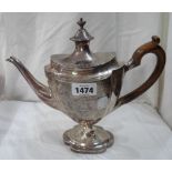 A silver pedestal teapot with flip-top, wooden scroll handle and engraved decoration with blank