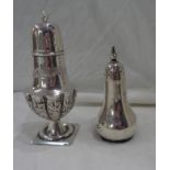 A silver ornate pedestal pepperette with embossed and engraved decoration - sold with another of