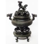 An antique Chinese cast bronze censer, stand and lid, the three footed censer with dragon head