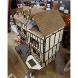 A very large doll's house in the Mock Tudor style with detachable pedestal base and some