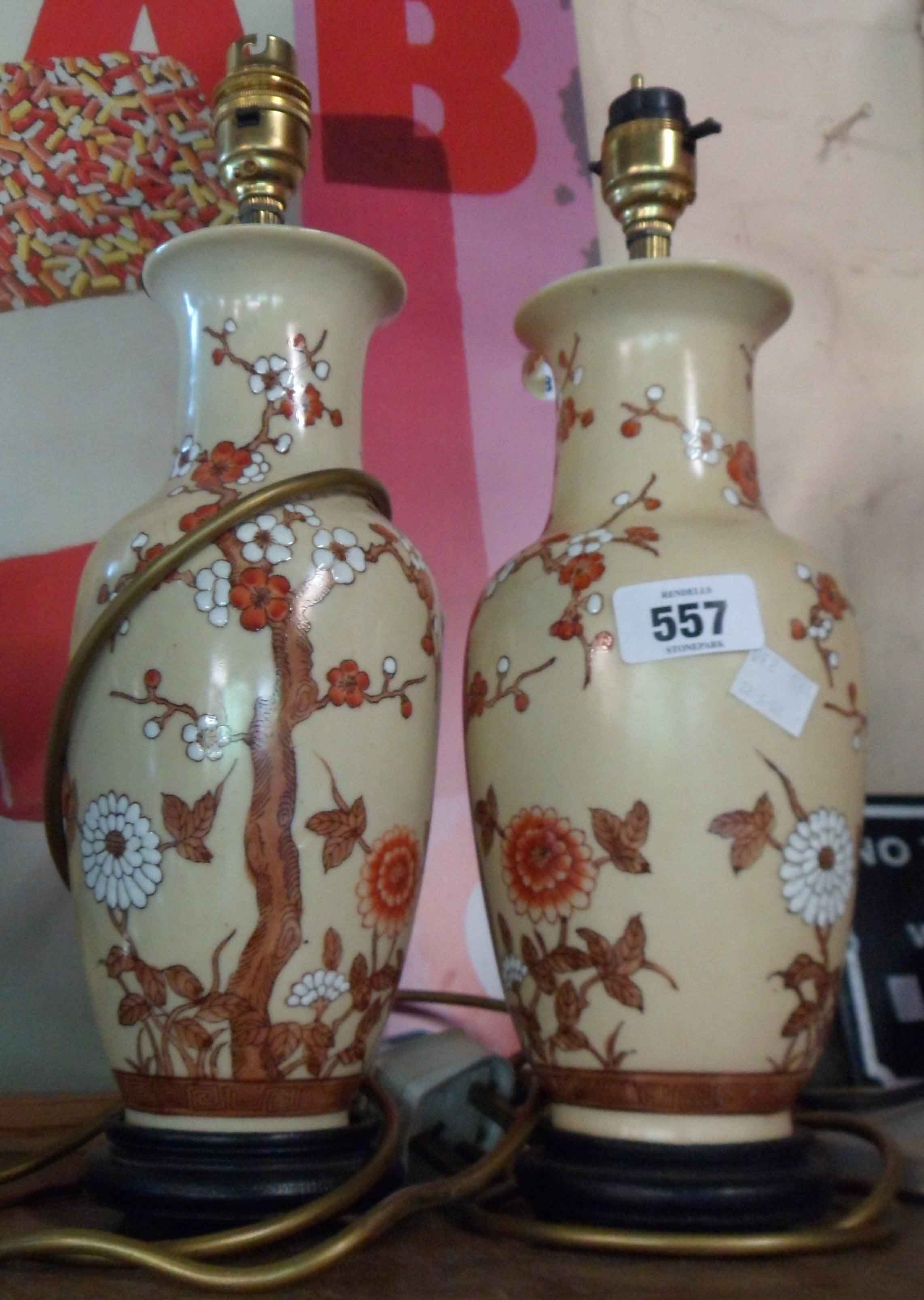 Two ceramic table lamps of vase form decorated with prunus blossom design