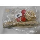 A bag containing a quantity of carved bone and ivory items including napkin rings, counters, etc.