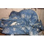 A pair of large blue lined curtains with all over decorative British motifs - complete with ties