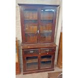A 1.06m late Victorian stained pine two section bookcase with pair of glazed panel doors to top over