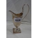 A silver pedestal cream jug with beaded and engraved decoration and initials to cartouche - by