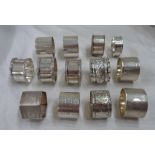 A collection of silver napkin rings including a pair with engine turned decoration and named
