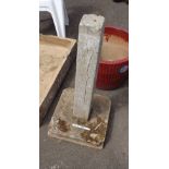 A concrete bird bath base