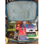 A suitcase containing a quantity of Dick Francis paper and hardback novels