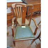 A pair of 20th Century quarter sawn oak framed panel back elbow chairs with leather upholstered