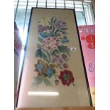 An old framed and glazed embroidered picture depicting flowers