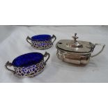 A pair of silver oval salts with pierced decoration and blue glass liners - sold with a silver