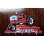 A modern painted cast iron McCormick Farmall tractor pattern key hook