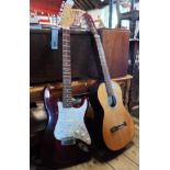 A Torre acoustic guitar and a Westfield strat copy electric guitar