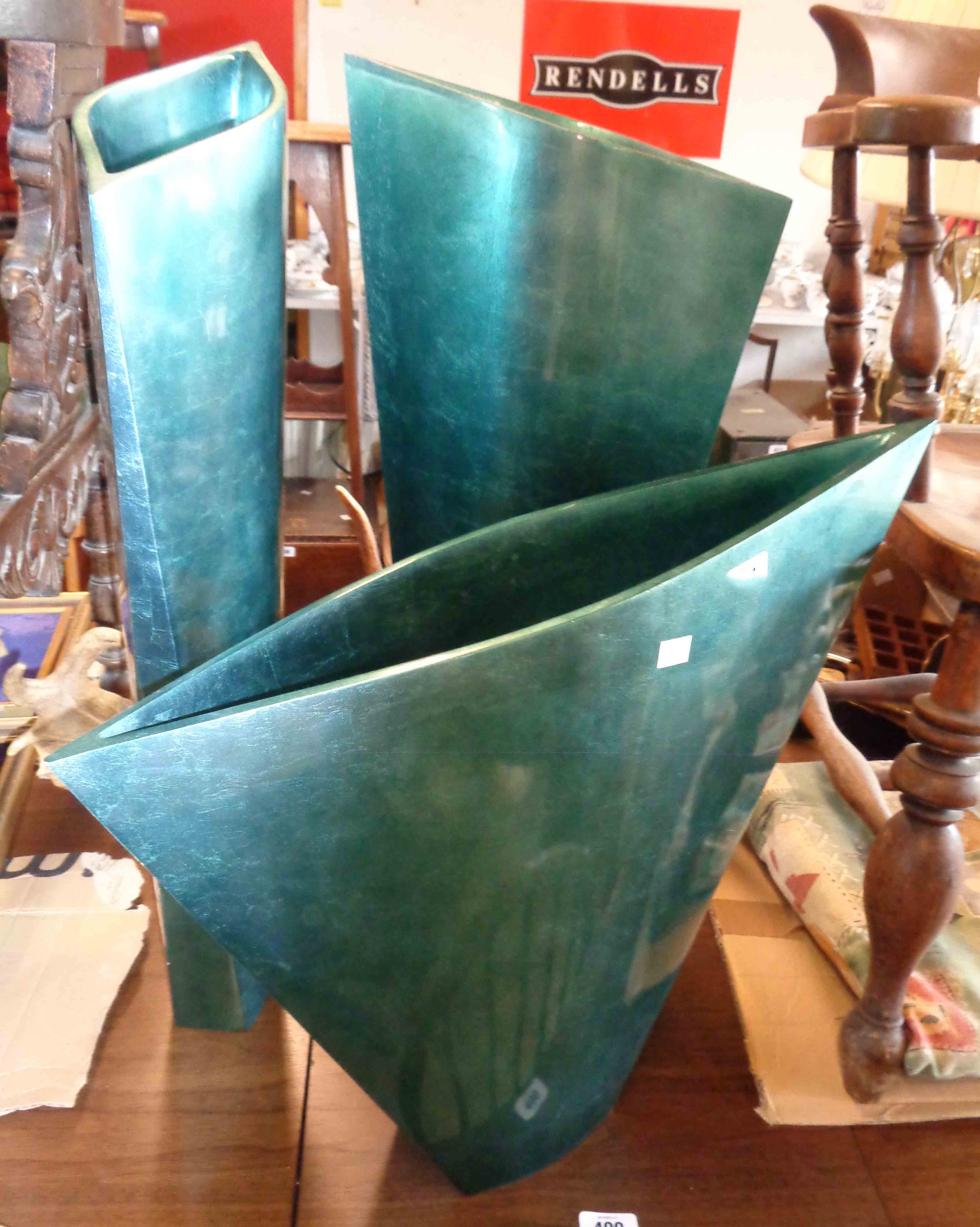 A garniture of three resin vases of flattened tapering form with green marbled metallic finish