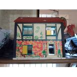 A vintage child's doll house with printed card sides