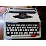 A vintage Brother Delux 850TR portable typewriter in original hardshell case