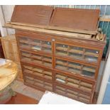A 2m vintage oak and mixed wood haberdashery unit with numerous slides enclosed by eight up-and-over
