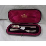 A leather cased fork and spoon christening set with engraved decoration and initials to