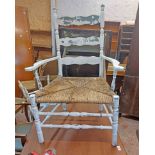 A painted wood framed ladderback elbow chair with rush seat and Shabby Chic finish